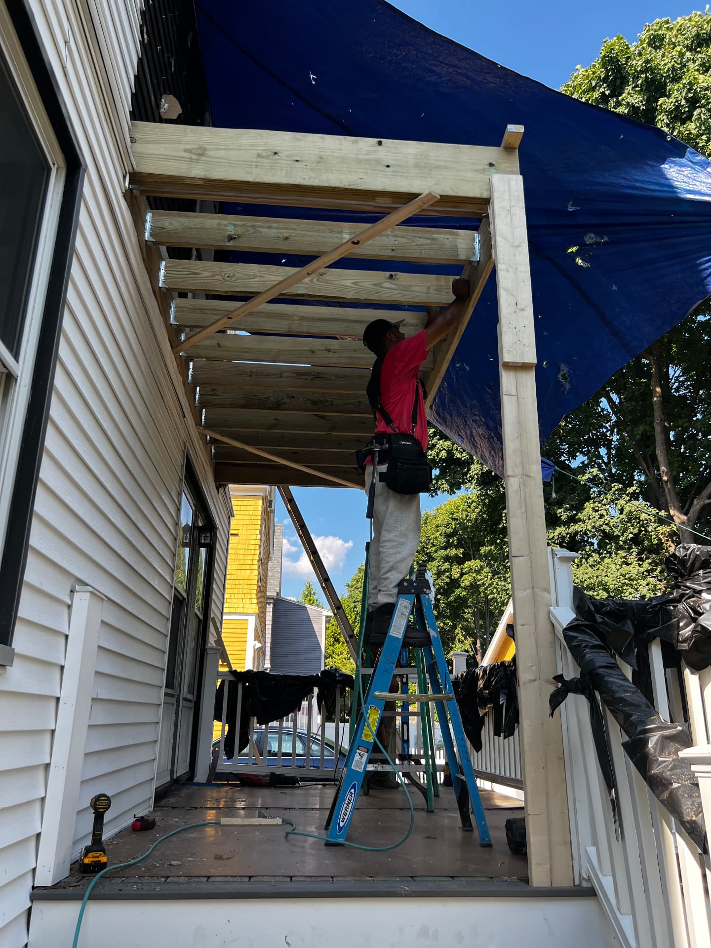 Carpenter framing the new porch roof structure