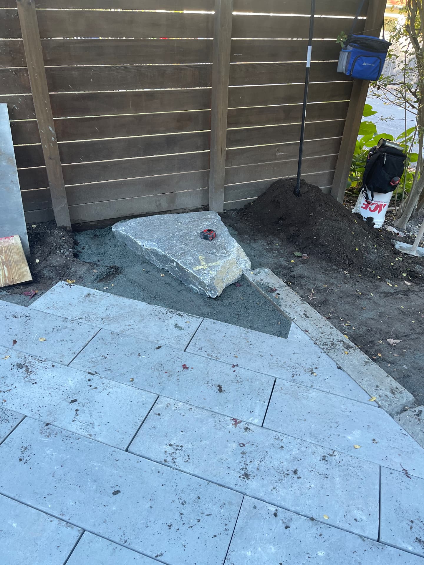 Granite step stone set in place beside the new bluestone paving