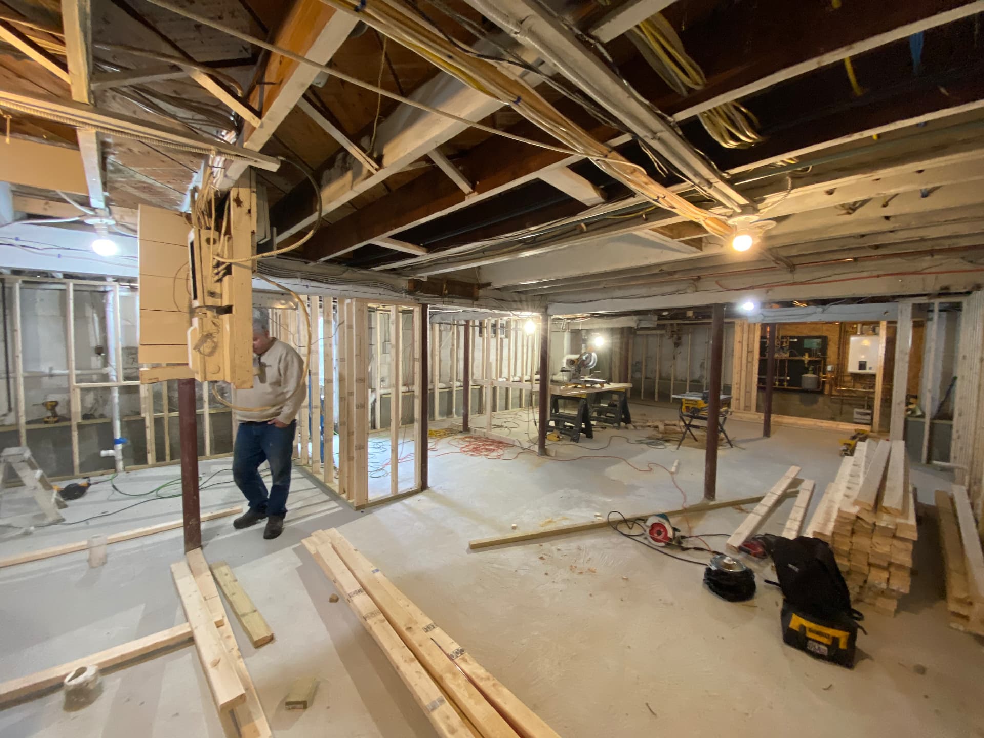 New slab poured with partition framing and mechanical rough-in underway