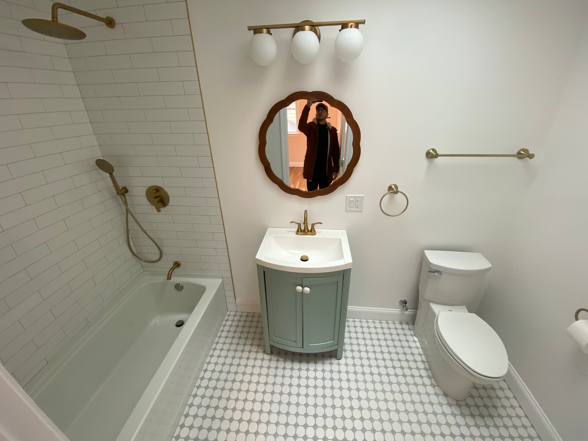 Guest bathroom with subway tile, brass fixtures and penny-round floor tile