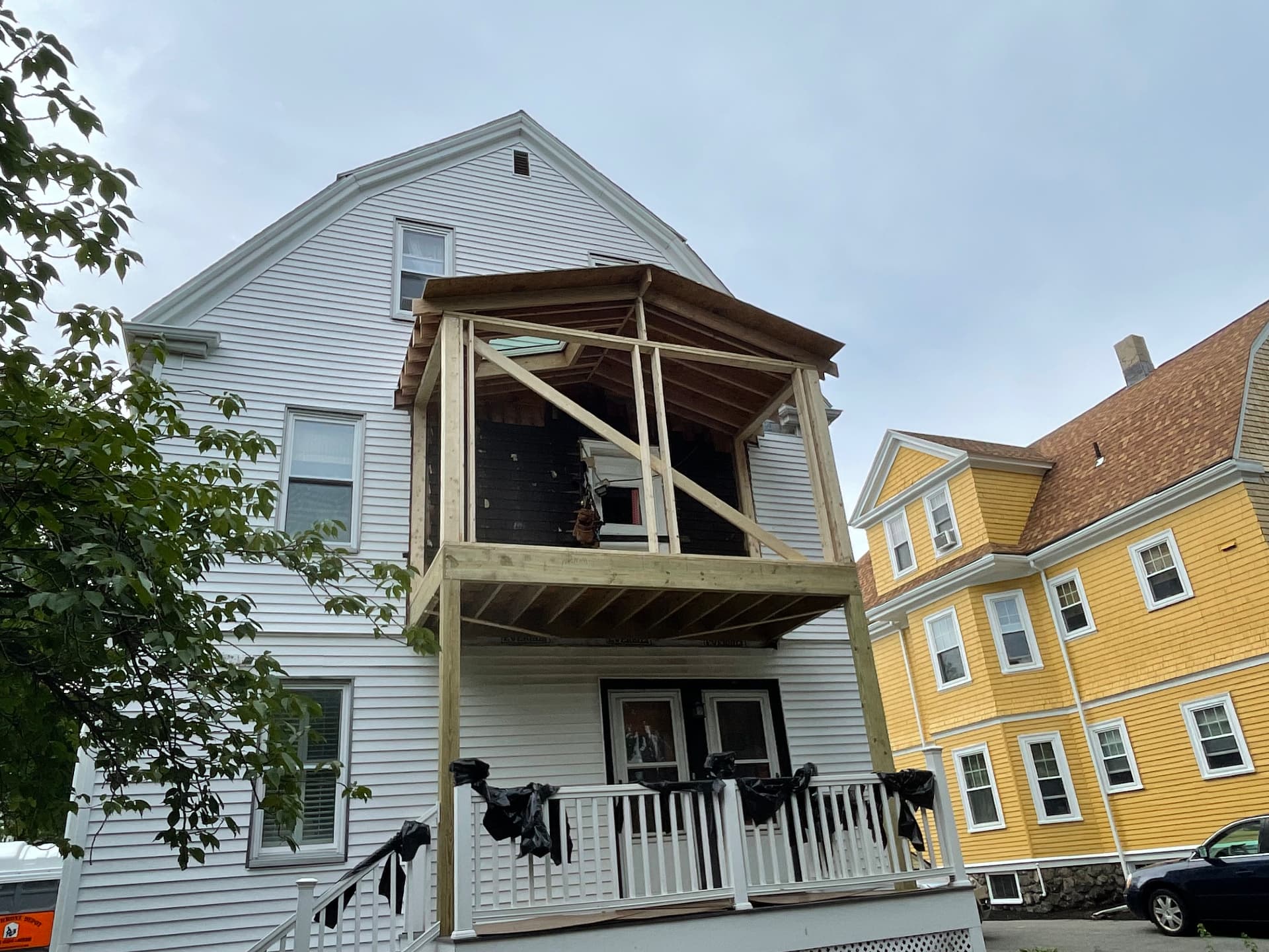 Framed covered porch structure with roof rafters in place