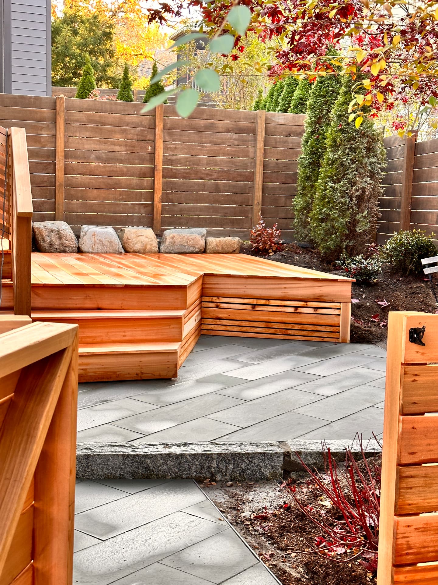 Cedar bench and wrapped deck edge with fieldstone backing
