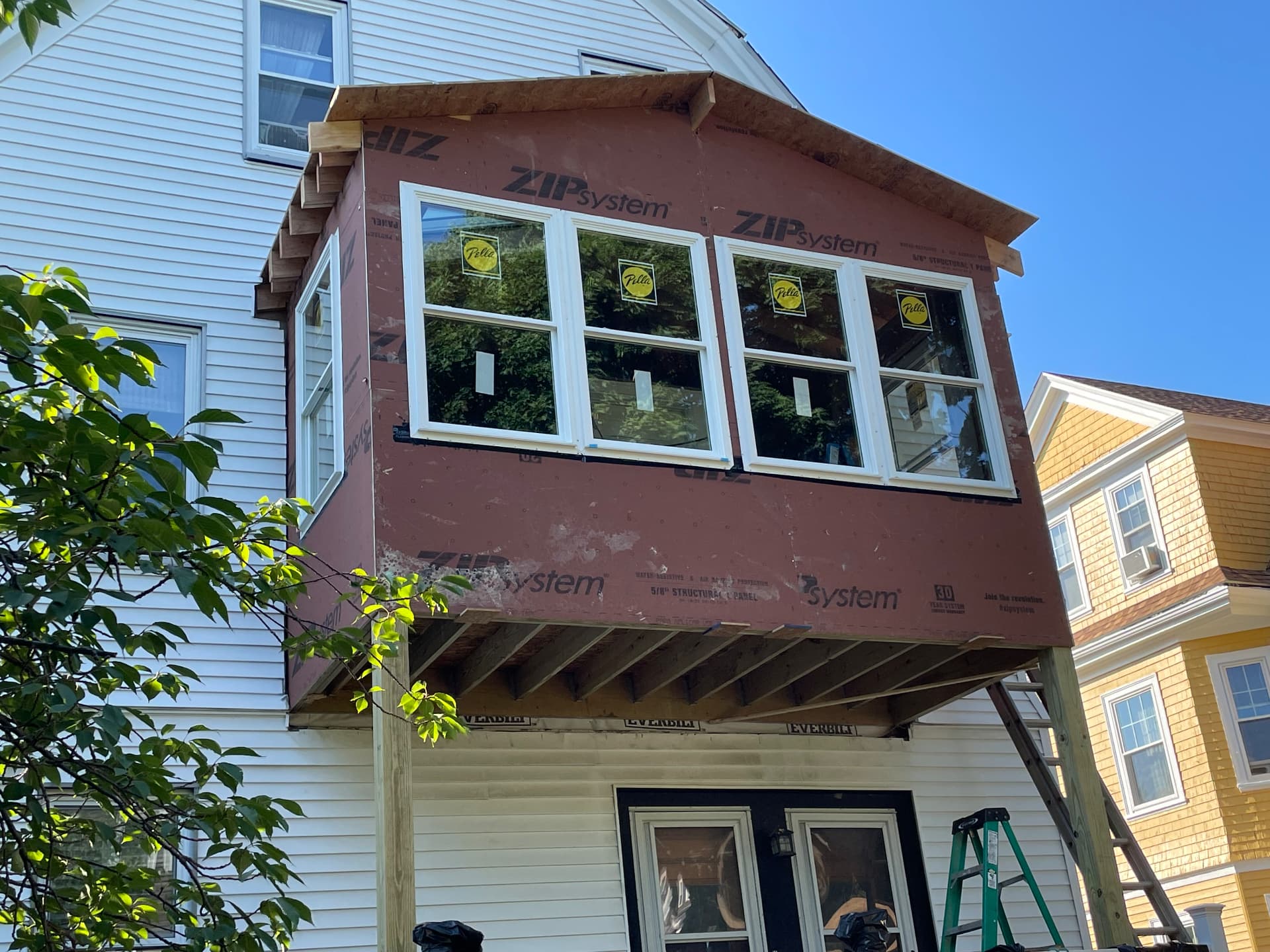 Sheathed porch exterior with new Pella windows installed