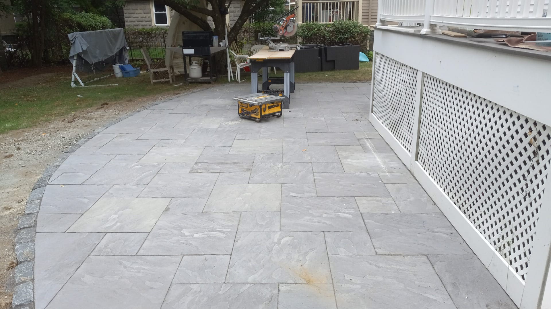 Finished bluestone patio laid alongside the rebuilt porch