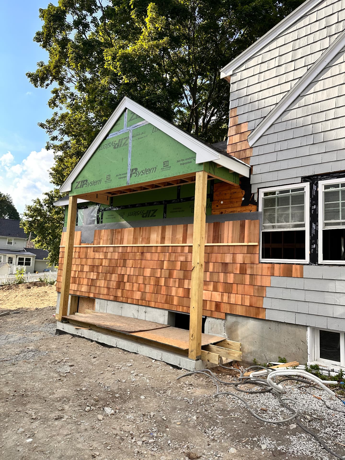 Cedar shingle siding and gable entry taking shape on the addition